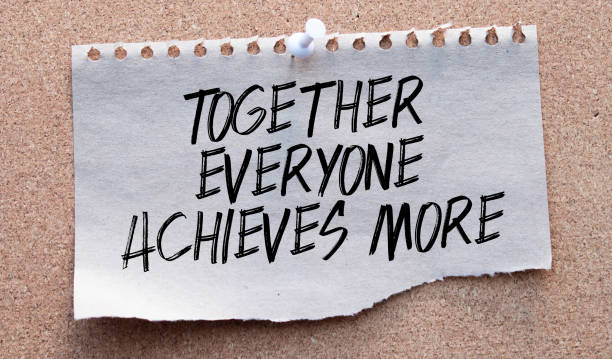 istock Together everyone achieves more phrase written with a typewriter. 1388654394