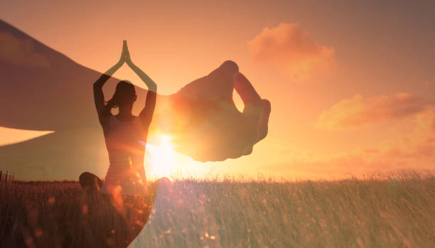 istock Woman meditating in the park at sunset. 1388654514