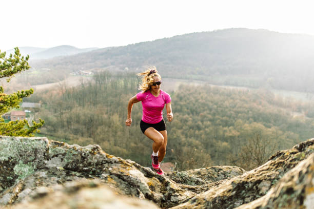 istock Strong woman running on mountain 1388655545