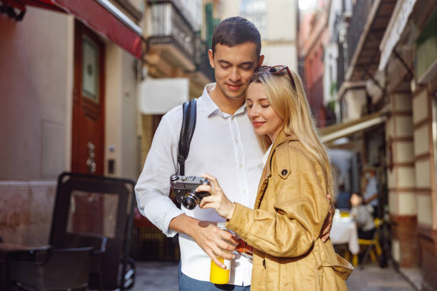 istock Charming couple looking at the camera standing on street 1388657071