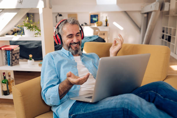 istock Mature entrepreneur having a web meeting from his living room 1388665914
