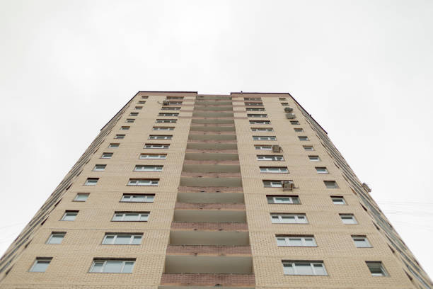 istock Tall building. Urban development. House from bottom up. Windows in row. 1388666999