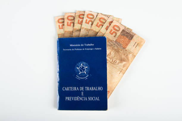 istock Brazilian document work and social security (Carteira de Trabalho e Previdencia Social) with Brazilian money banknotes 1388670733