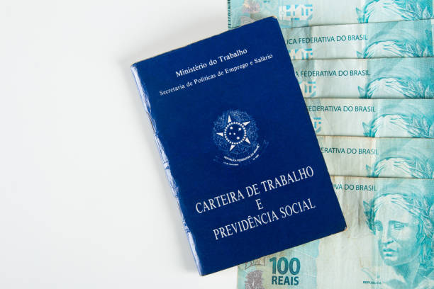 istock Brazilian document work and social security (Carteira de Trabalho e Previdencia Social) with Brazilian money banknotes 1388670751