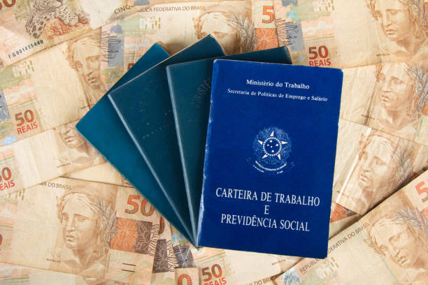 istock Brazilian document work and social security (Carteira de Trabalho e Previdencia Social) with Brazilian money banknotes 1388670795