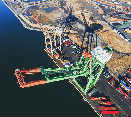 Aerial drone view of a container port gantry crane.