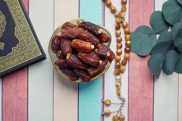istock Holy book Quran and rosary on table, close up. 1388677860