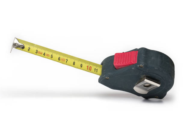 istock Closeup rolling tape measure meter white background 1388682763