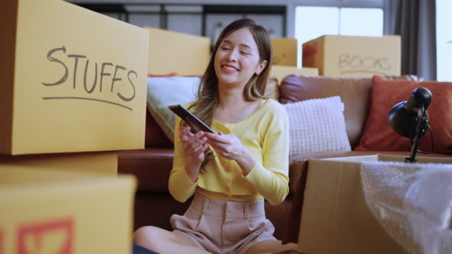 asian female calling to say goodbye all good friend neighborhood after finish packing her things and ready to relocation moving to her new house home moving ideas concept
