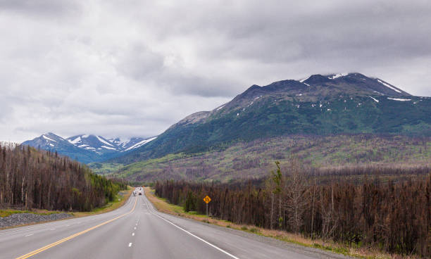 The Sterling Highway on its way into Cooper Landing in Alaska. The Kenai River runs through Cooper Landing and is the longest river in the Kenai Peninsula of south central Alaska. It runs 82 miles westward from Kenai Lake in the Kenai Mountains, through the Kenai National Wildlife Refuge and Skilak Lake to its outlet into the Cook Inlet of the Pacific Ocean near Kenai and Soldotna.