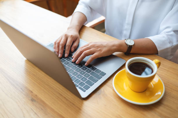 istock Closeup image of a woman working and typing on laptop computer keyboard on the table 1388692972