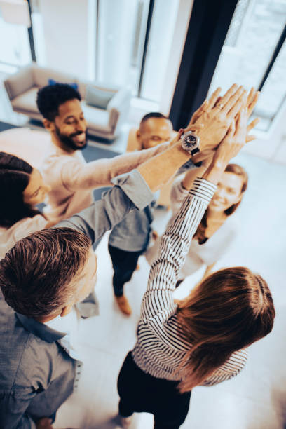 work together to win together - hand raised arms raised multi ethnic group human hand imagens e fotografias de stock