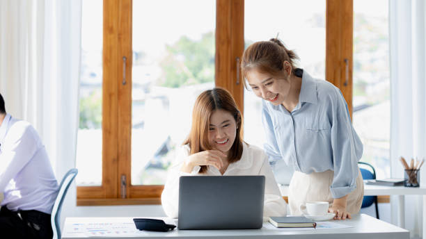 istock Two Asian women are working together, consulting and brainstorming to analyze data to devise marketing plans for growth companies, start-up executives and employees. Management startup company. 1388693996