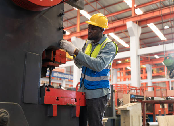 istock Engineer or foreman hard work with paperwork and machine at factory 1388695670
