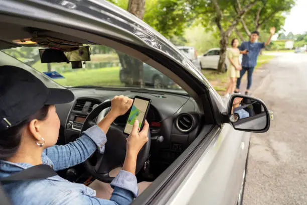 crowdsourced taxi driver picking up customer at roadsided, using gps to navigate to destination