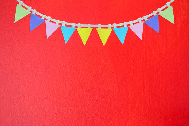 istock Flag garland on abstract red wall texture background 1388702037