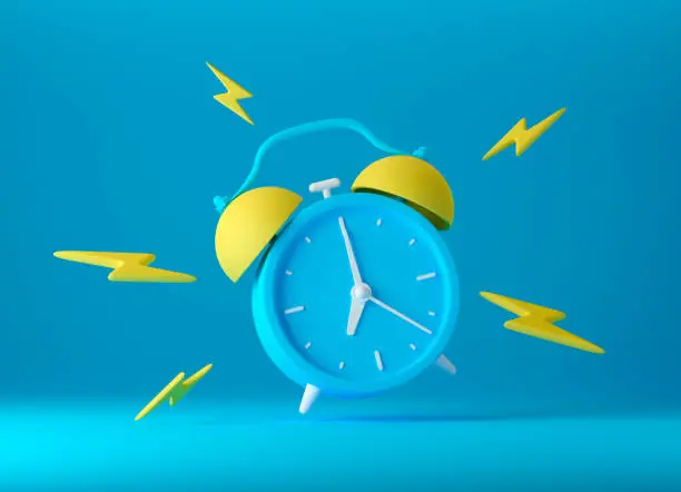 Photo of Blue vintage ringing alarm clock with bright yellow lightings