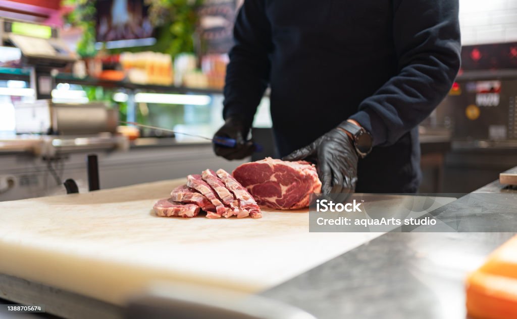 Cutting Meat Hands Of A Butcher Cutting Meat On The Cutting Board In Butcher Shop Meat Stock Photo