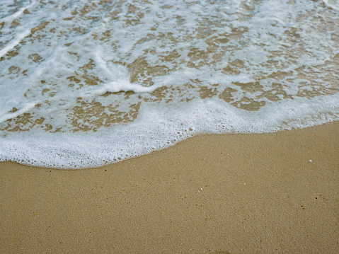 Soft wave lapped the sandy beach