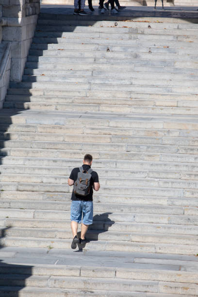 istock people walking by stone stairs with backpack 1388707205