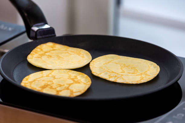 istock Cooking pancakes in a pan 1388709771