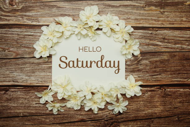 istock Hello Saturday card typography text with flower bouquet on pink background 1388709888