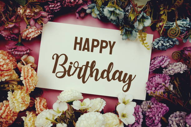 istock Happy Birthday typography text with flowers frame on pink background 1388710181