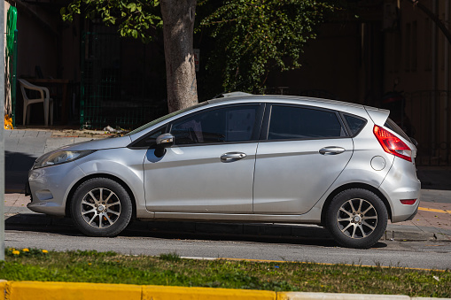 Side; Turkey – March 01 2022:      silver  Ford Fiesta   is parked  on the street on a warm   day