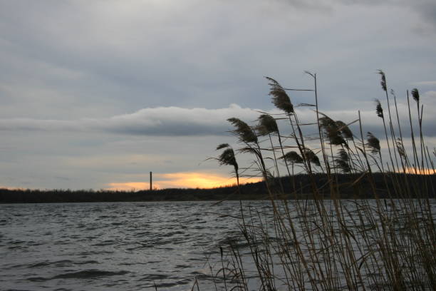 istock Sunset behind the calm lake water 1388712675