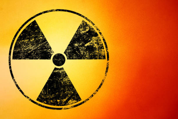 istock Black radioactive sign over yellow background 1388713001