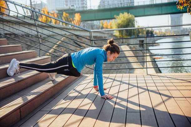 istock Happy young woman practicing on all fours using staircase by the river 1388715087