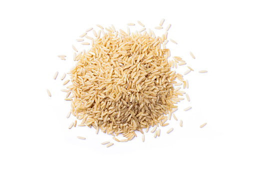 Pile of coarse brown rice isolated on white