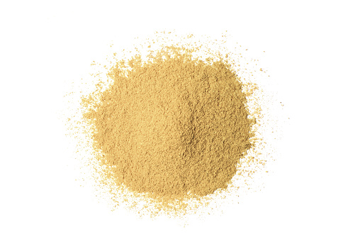 Heap of ginger powder or dry plant powder isolated on white background. Top view. Flat lay.