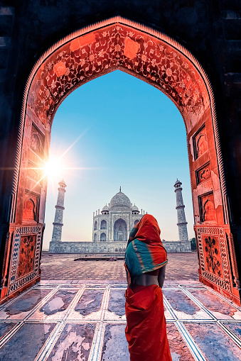 Indian woman looking at the Taj Mahl mausoleum in Agra city