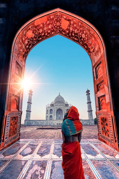 Taj Mahal mausoleum in Agra Indian woman looking at the Taj Mahl mausoleum in Agra city indian dome stock pictures, royalty-free photos & images