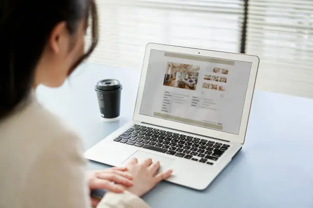 Photo of Asian women viewing real estate websites on a computer