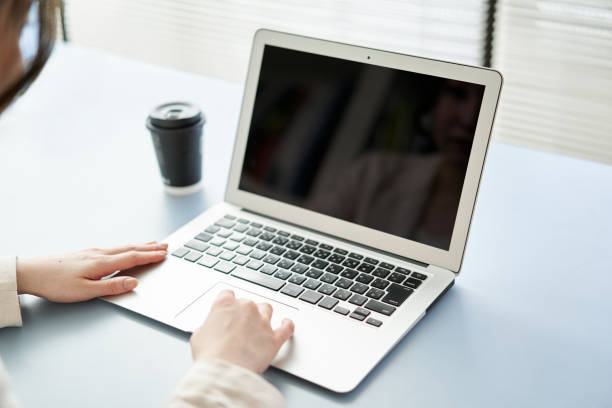 Asian woman operating a laptop