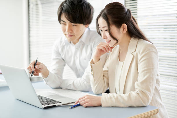 istock Asian architect having a meeting by looking at a computer 1388719859