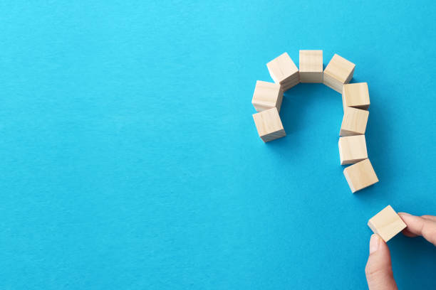 istock Question mark made of wooden blocks with copy space on blue background 1388719903