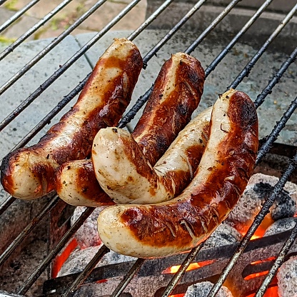Grilled sausages, German bratwurst specialties, on the grill
