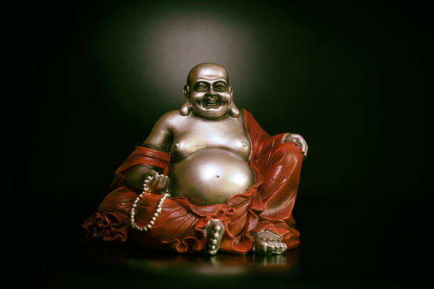 istock Buddha in atmospheric dark lighting with side light and selective focus 1388723163