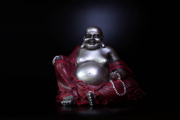 istock Buddha in atmospheric dark lighting with side light and selective focus 1388723223