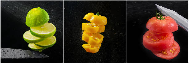 Sweet pepper, lime and tomato, sliced on the fly in a spray, black background. Cooking concept, collage stock photo