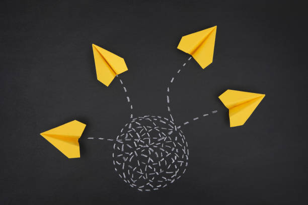 istock Paper Airplanes Flying out of Tangled Path 1388725408
