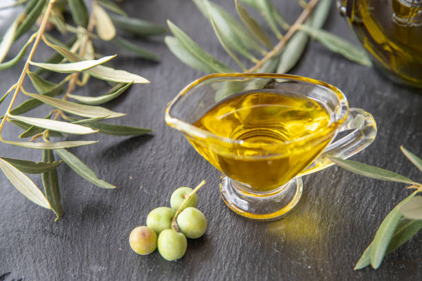 istock green olives with olive oil on a dark background 1388728302