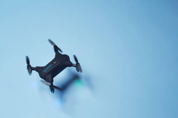 istock Drone flying above the bright solid blue fond background 1388728887