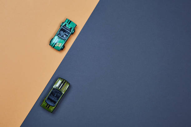 istock Two micro toy small mini cars opposite direction top view 1388728899