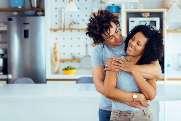 istock Beautiful cheerful couple relaxing in their kitchen 1388729061