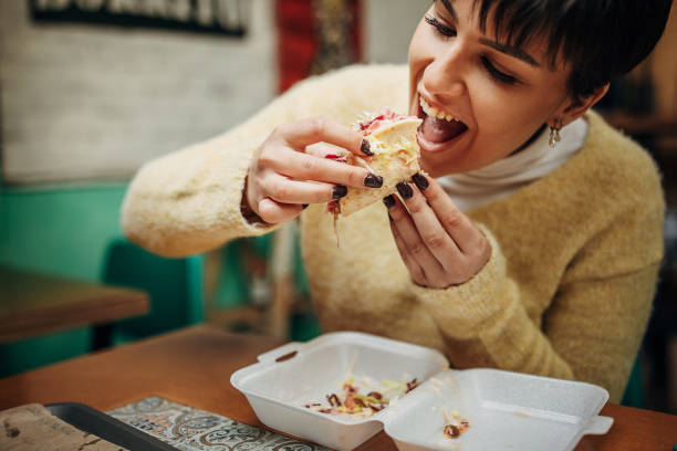 istock Woman eating burritos 1388730740