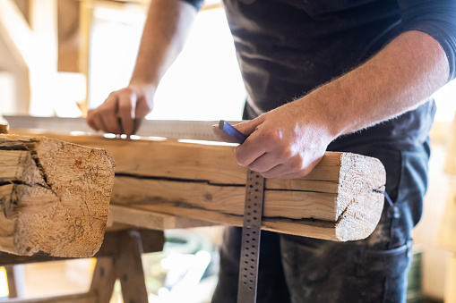 Carpenter takes measurements